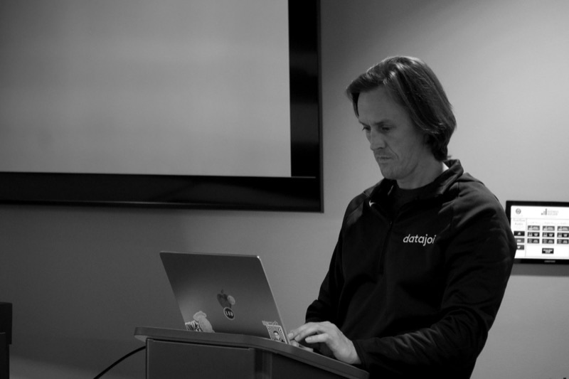 David Wrench working at a podium laptop