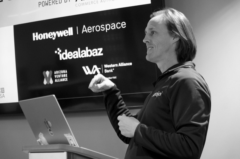David Wrench presenting in front of a screen showing partner logos